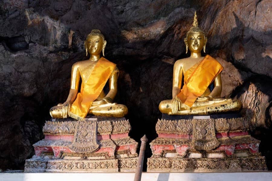 Gilded Buddha figures in the cave shrine at Suwankuha temple