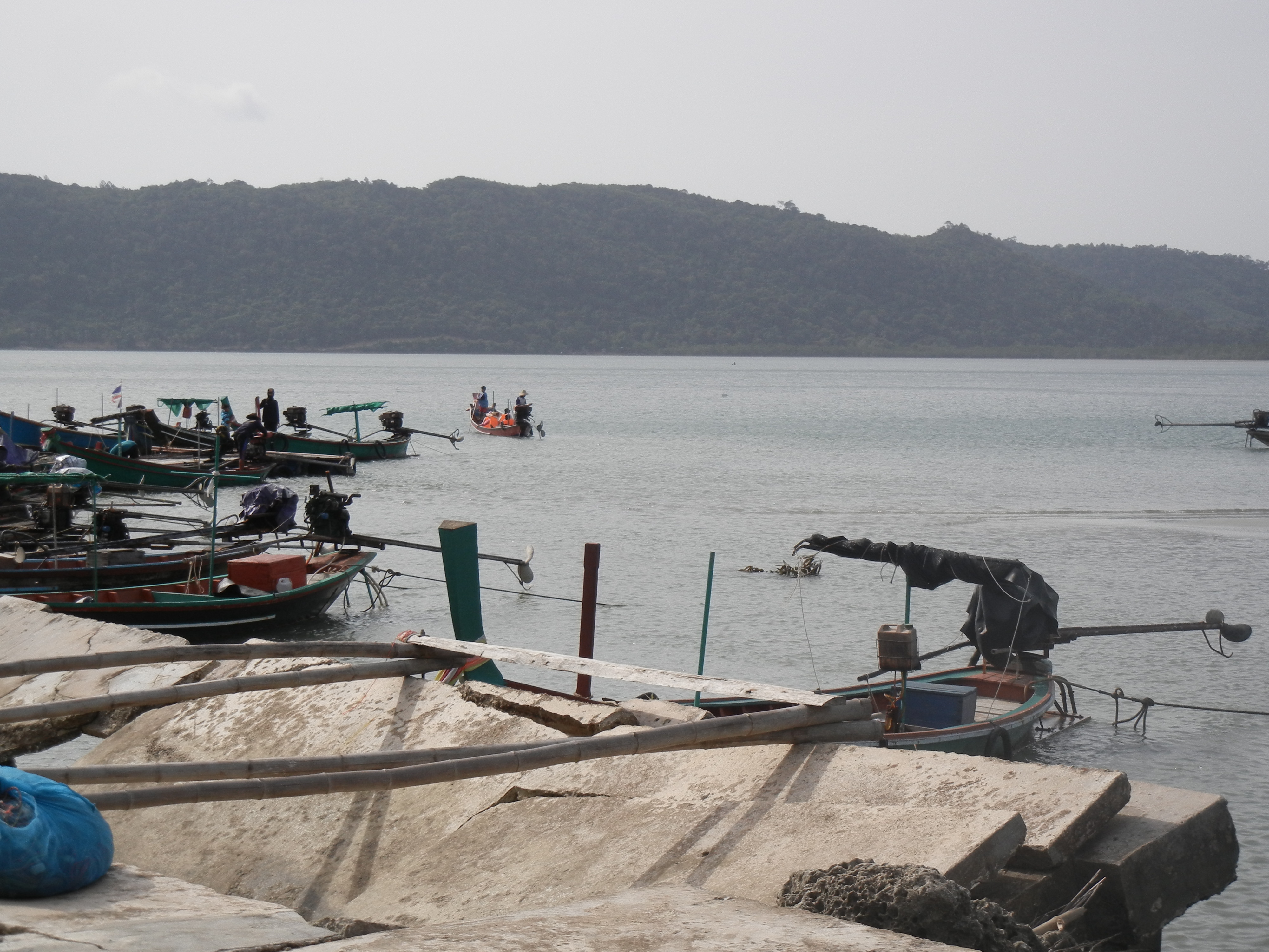 Longtail boats at a Khanom pier in the early morning, ready for the pink-dolphin run
