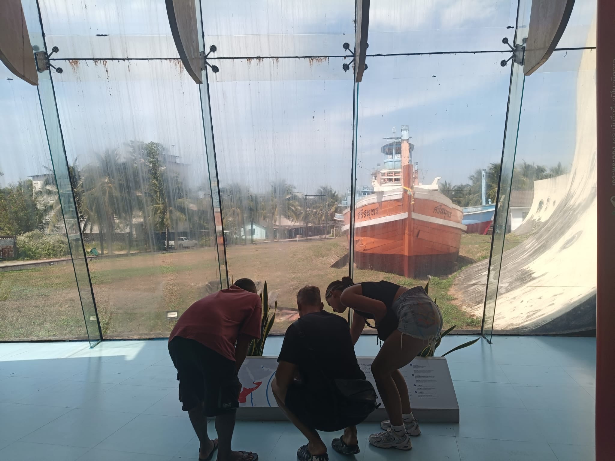 The tsunami museum's glass wall framing a salvaged boat