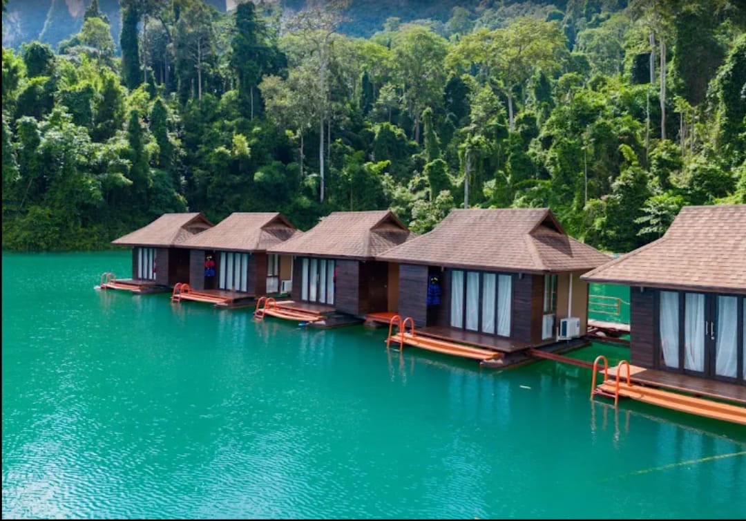 A line of floating bungalows on jade-green water