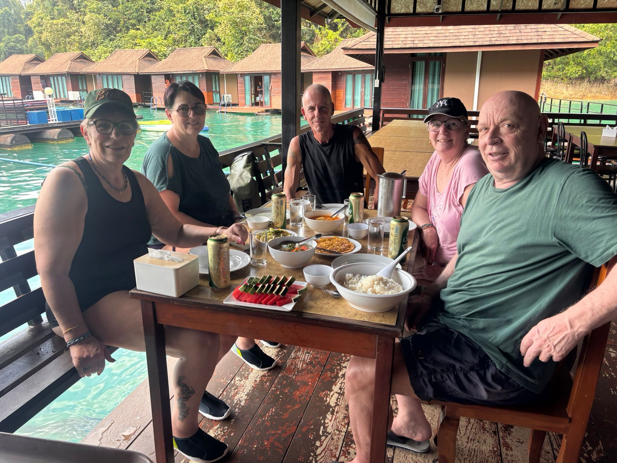 Guests at a raft-house dining table over the water