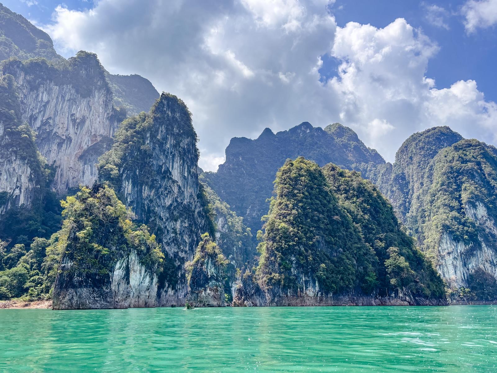 A cluster of green karst islands above the emerald water of Cheow Lan Lake
