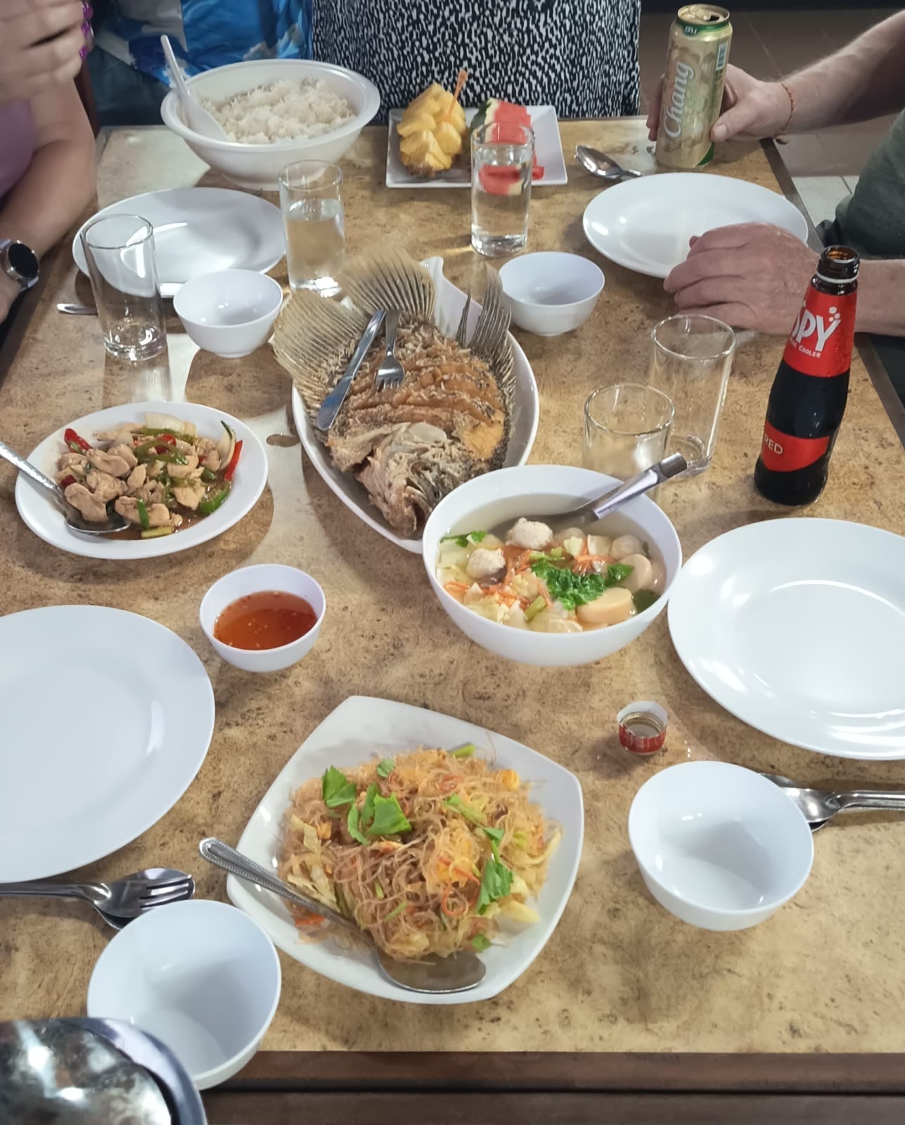 A lunch spread of whole fried fish, soup, stir-fry and rice