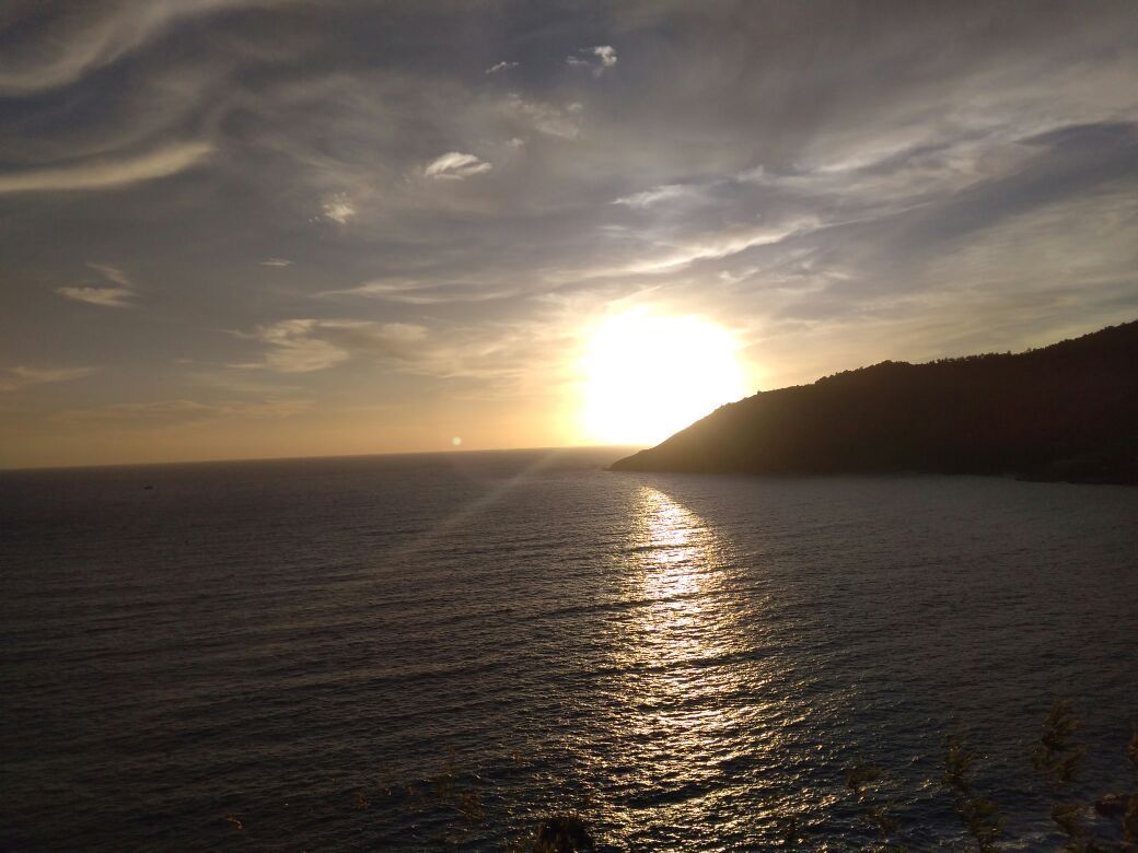 The sun dropping behind a headland over the Andaman